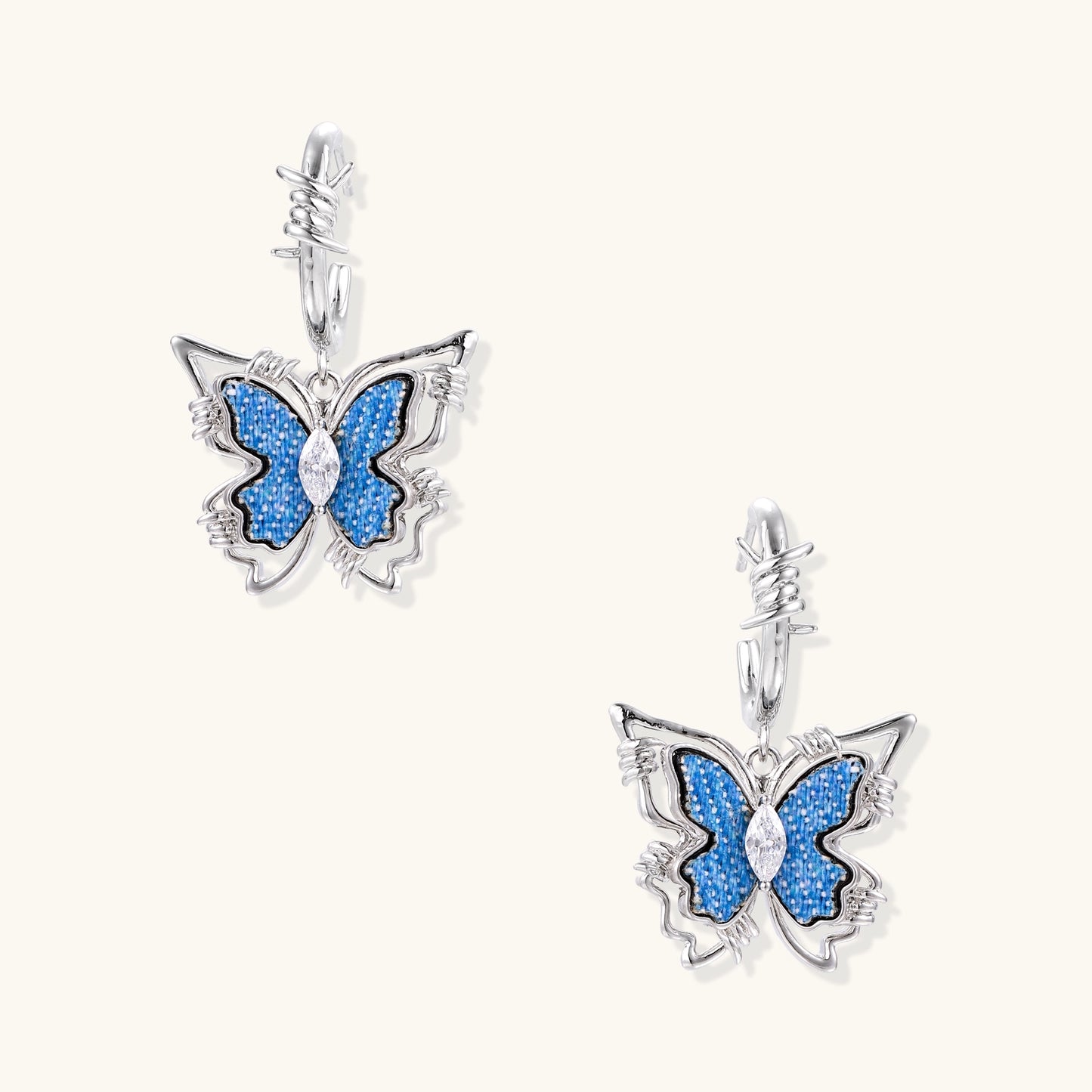 Pair of gold-plated hoop earrings featuring butterfly charms with blue textured wings and clear zirconia accents