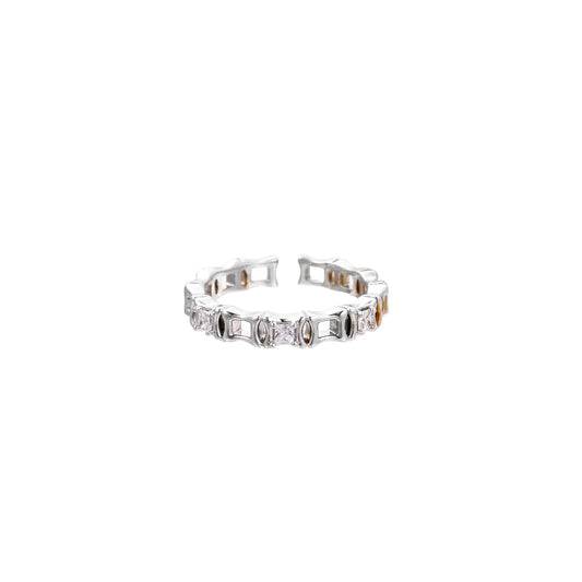 White gold plated ring with architectural lattice design and zirconia accents on cream background