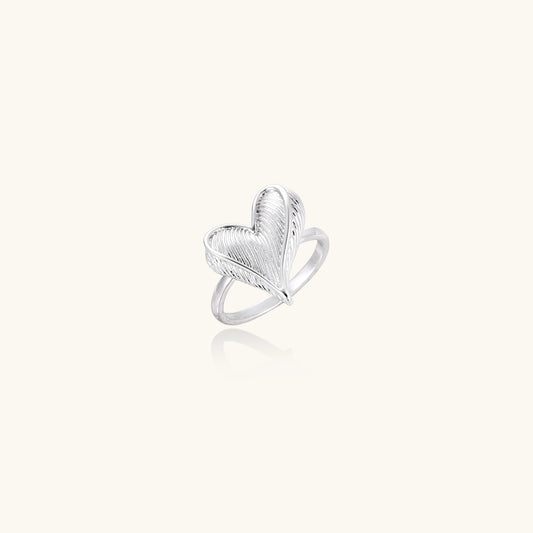18K gold plated brass ring with intricate feather design forming a heart shape on white background.