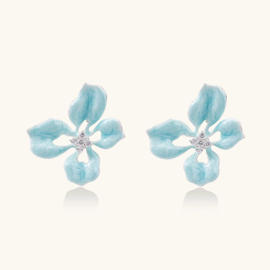 Turquoise blue enamel flower earrings with crystal centers and gold-plated brass posts on white background.