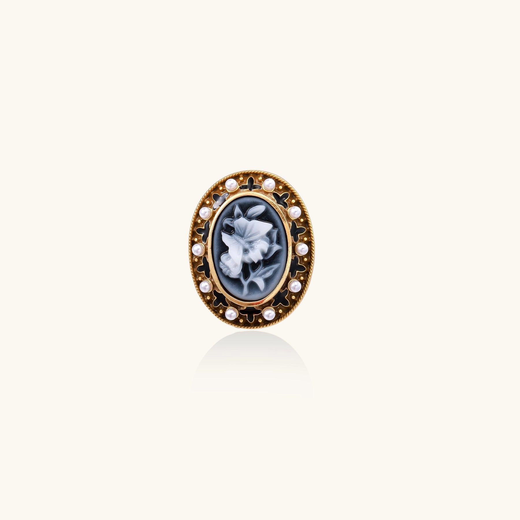 Oval cameo ring with blue-grey floral design surrounded by white shell pearls in gold-plated brass setting