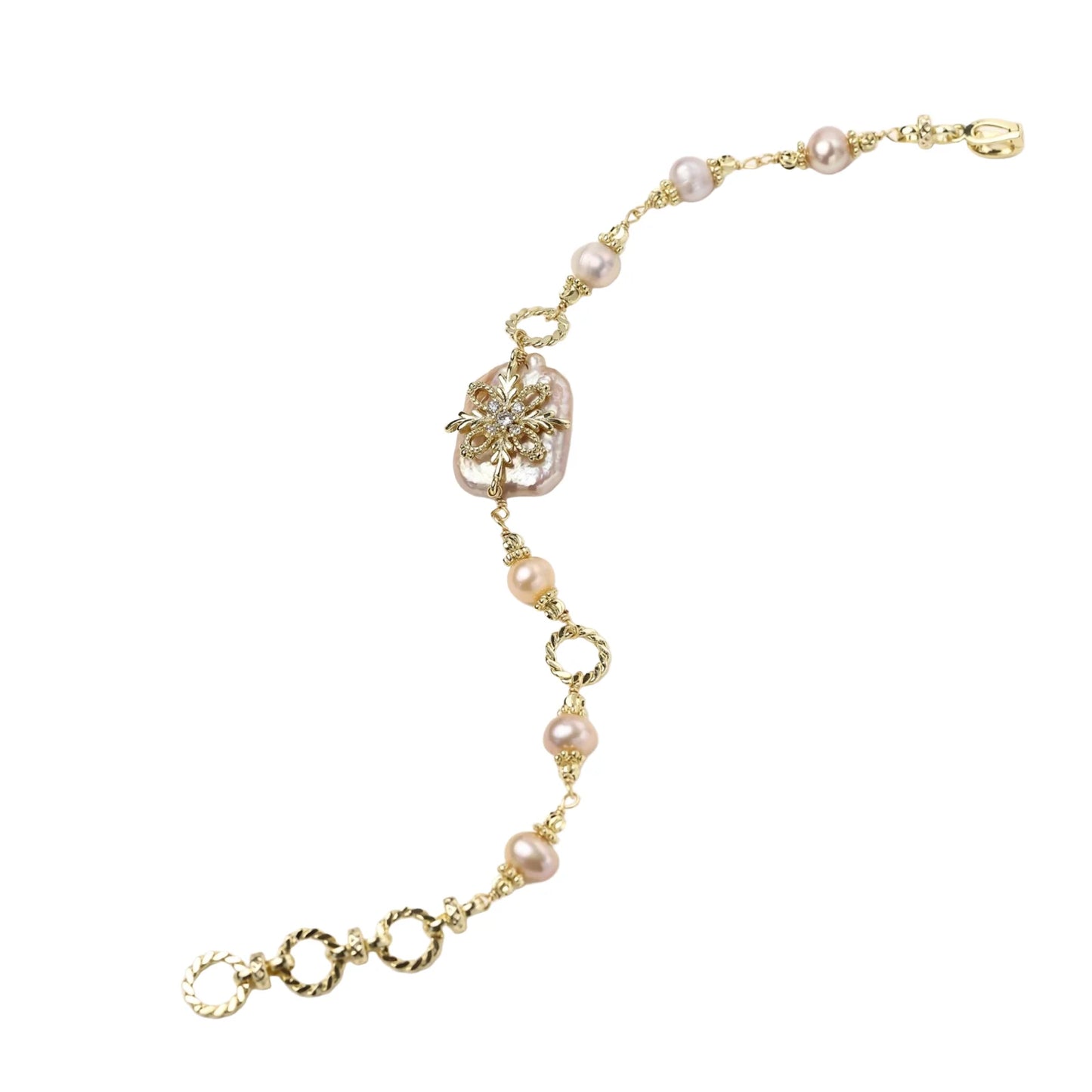 Gold-plated bracelet with pink baroque pearl centerpiece, floral connector, and freshwater pearls